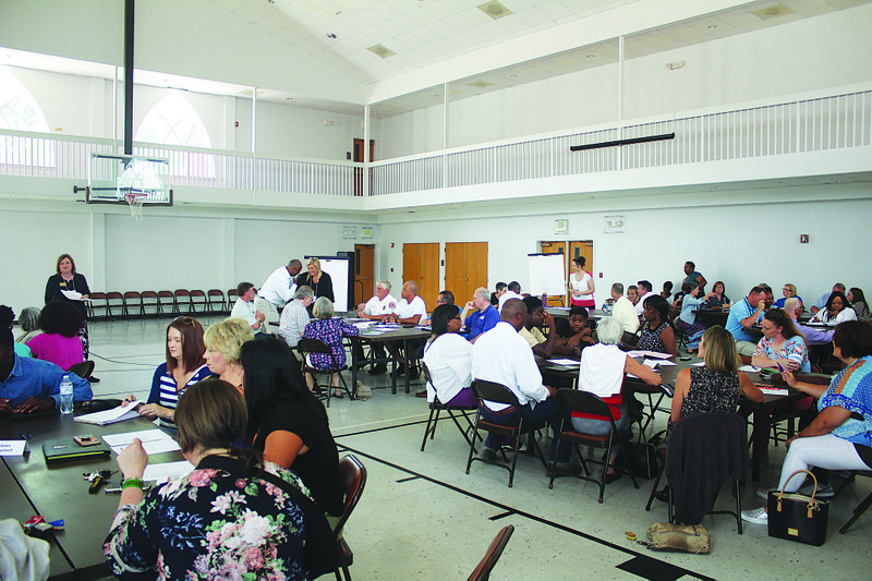 The Community Development Institute holds a meeting with local residents during August.