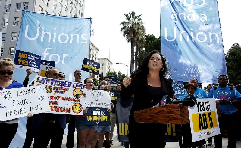 California Assemblywoman Lorena Gonzalez speaks last month at a Sacramento rally advocating for her legislation to limit companies’ ability to label workers as independent contractors. Gonzalez said in a statement Wednesday that “California is now setting the global standard for worker protections for other states and countries to follow.”