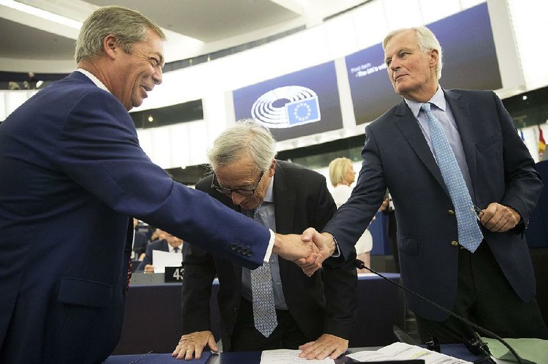Nigel Farage (left), leader of the U.K.’s Brexit Party, meets with European Union negotiator Michel Barnier (right) and European Commission President Jean-Claude Juncker on Wednesday in Strasbourg, France. 