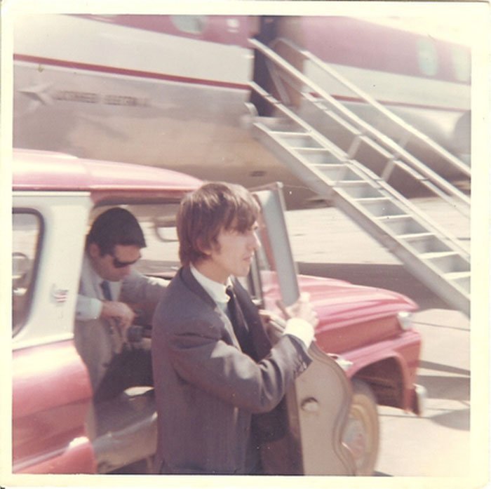 George Harrison awaits the Beatles' boarding of an airplane in 1964 in Walnut Ridge. Photo by Carrie Mae Snapp