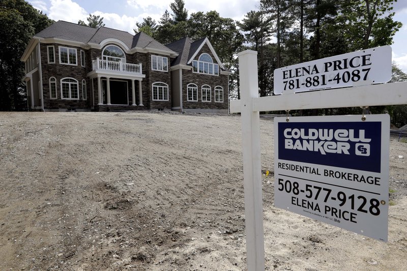In this Tuesday, Sept. 3, 2019 photo a sign rests in front of a newly constructed home, in Westwood, Mass. On Wednesday, Sept. 18, the Commerce Department reports on U.S. home construction in August. (AP Photo/Steven Senne)