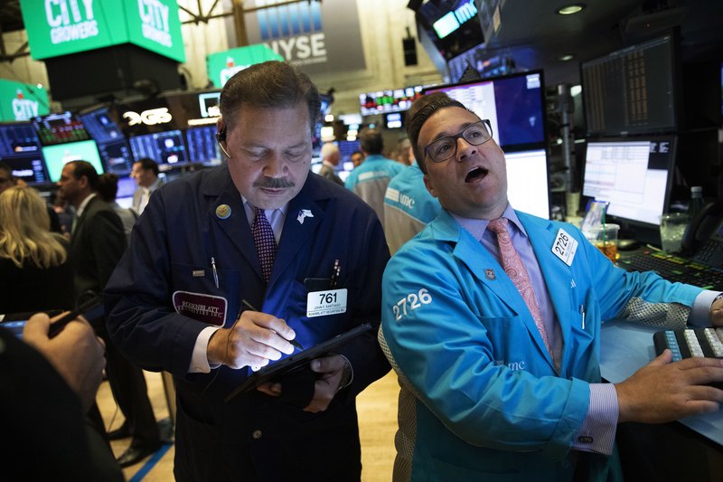 Stock traders John Santiago, left, and Paul Cosentino work at the New York Stock Exchange, Wednesday, Sept. 18, 2019.  (AP Photo/Mark Lennihan)
