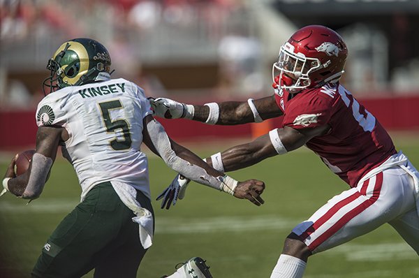 Arkansas cornerback Montaric Brown tries to tackle Colorado State running Marvin Kinsey during a game Saturday, Sept. 14, 2019, in Fayetteville. 