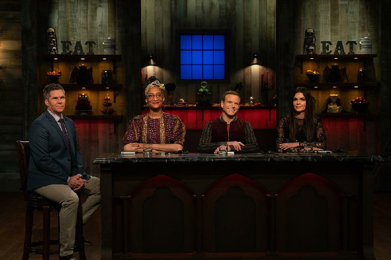 John Henson (left) is host, and Carla Hall, Zac Young and Katie Lee are judges on Food Network’s Halloween Baking Championship.