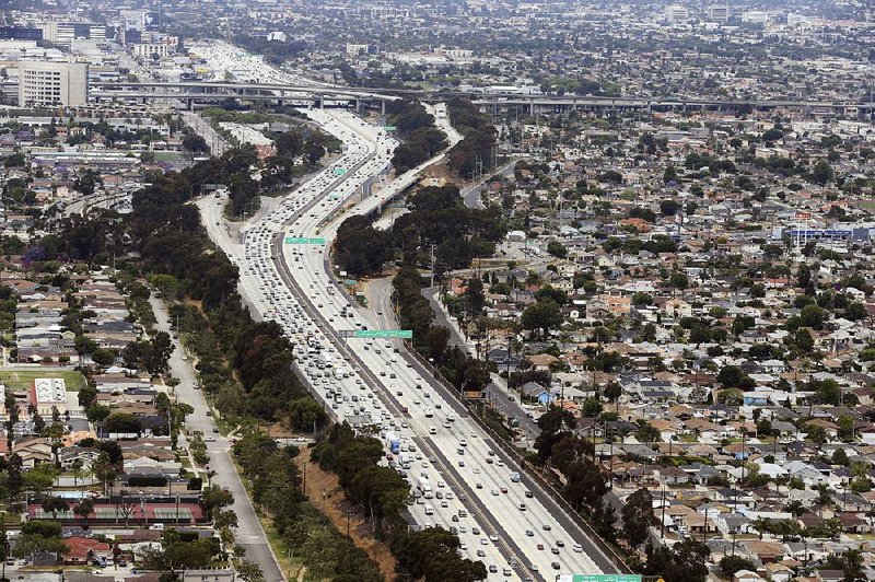 President Donald Trump’s administration on Thursday revoked California’s authority to limit greenhouse gas emissions caused from motor vehicles such as these passing near Los Angeles International Airport on the San Diego Freeway in 2017. 