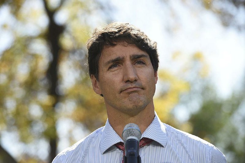 Canadian Prime Minister Justin Trudeau pauses Thursday in front of a large crowd in Winnipeg, Manitoba, as he asks forgiveness for putting on dark makeup. “I have always acknowledged I came from a place of privilege, but now I need to acknowledge that comes with a massive blind spot,” he said to applause.