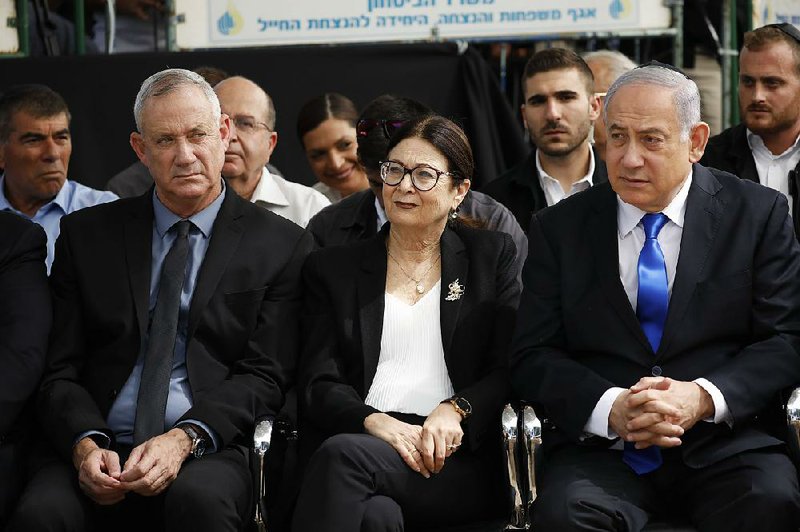 Blue and White party leader Benny Gantz (left), Esther Hayut, chief justice of the Supreme Court of Israel, and Prime Minister Benjamin Netanyahu attend a memorial service Thursday for former President Shimon Peres in Jerusalem. 
