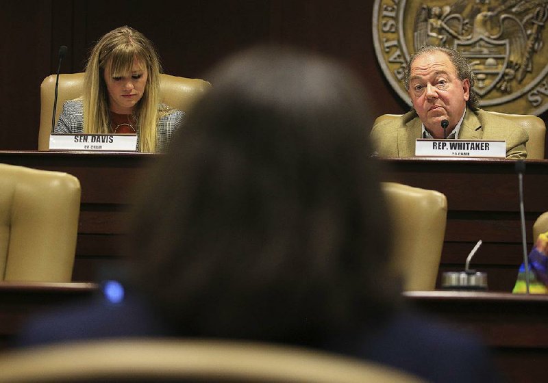 Co-chairman Sen. Breanne Davis (left), R-Russellville, and David Whitaker, D-Fayetteville, listen to University of Arkansas at Little Rock Chancellor Christina Drale speak Thursday at the state Capitol during a meeting of the Arkansas Legislative Council Higher Education subcommittee.
