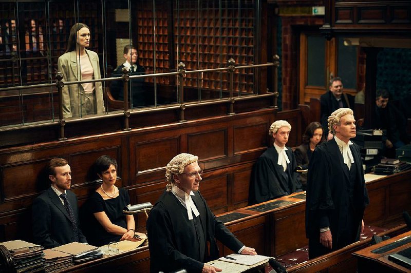 Katharine Gun ( Keira Knightley) stands in the dock as her bewigged barrister Ben Emmerson (Ralph Fiennes) and prosecutor Mark Ellison (Angus Wright) go through the motions in Official Secrets. 