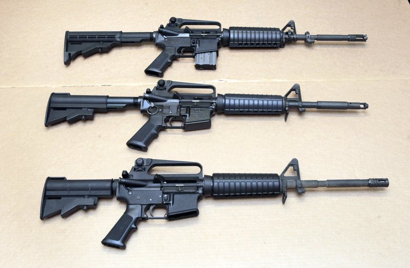 In this Aug. 15, 2012 file photo, three variations of the AR-15 rifle are displayed at the California Department of Justice in Sacramento, Calif. On Sept. 19, 2019, Connecticut-based Colt Firearms said it was suspending production of its version of the AR-15 for the civilian market. (AP Photo/Rich Pedroncelli, File)