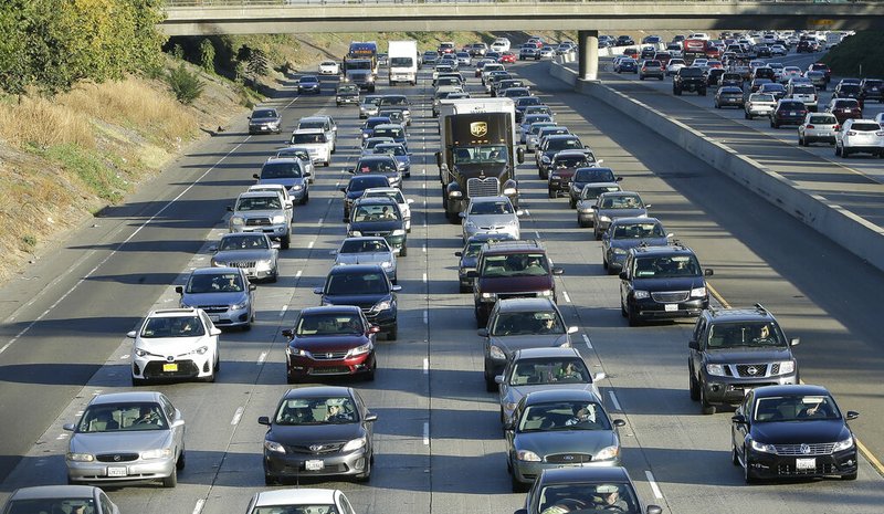 In this Monday, Oct. 30, 2017, file photo, vehicles crowd Highway 50 in Sacramento, Calif. California Attorney General Xavier Becerra announced, Friday Sept. 20, 2019 that 23 states have filed a lawsuit to stop the Trump administration from revoking California's authority to set emission standards for cars and trucks. (AP Photo/Rich Pedroncelli, File)