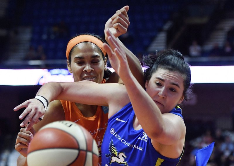 Connecticut Sun center Brionna Jones, left, and Dallas Wings forward Megan Gustafson tangle while going for a rebound during a Sept. 4 game in Uncasville, Conn. Gustafson recently finished her rookie season in the WNBA and is off to Hungary for pro basketball in the winter. Photo by Sean D. Elliot of The Day via The Associated Press