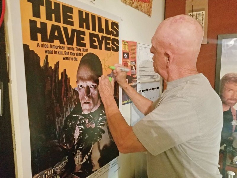 Michael Berryman, who starred in the 1977 horror movie The Hills Have Eyes, signs a poster of the movie during last year’s Hot Springs International Horror Film Festival. This year’s festival is scheduled to begin Thursday.
