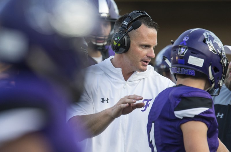 Casey Dick, Fayetteville head coach, congratulates players after a turnover in the first quarter vs St. Louis Vianney Friday, Aug. 30, 2019, at Fayetteville's Harmon Stadium.