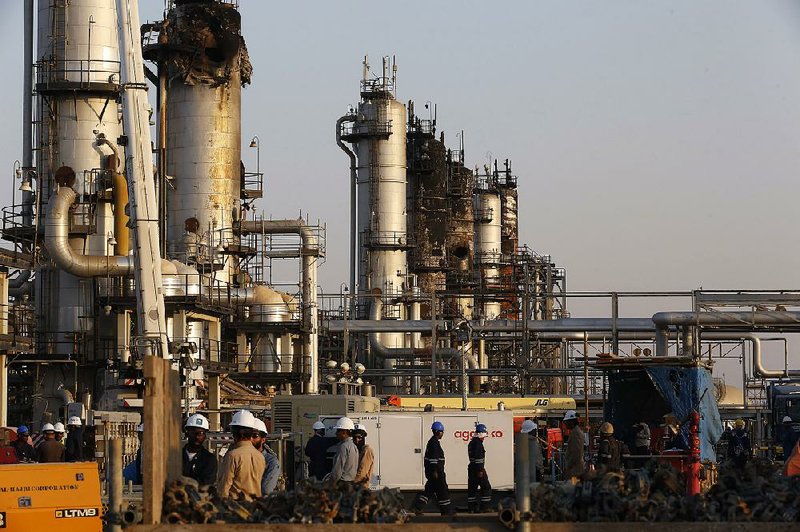 Workers on Friday repair Aramco’s oil-processing facility in Abqaiq, Saudi Arabia, that was damaged Sept. 14 in a missile and drone attack. 