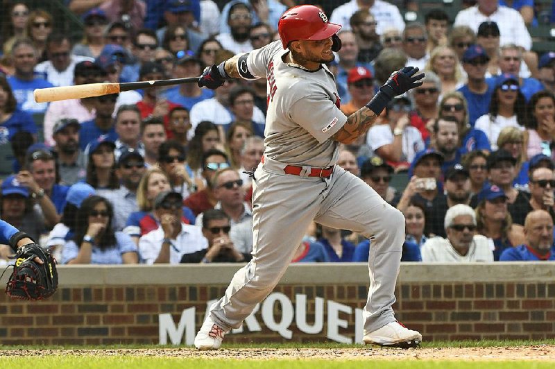 Yadier Molina of the St. Louis Cardinals hits a two-run single during the sixth inning Friday against the Chicago Cubs in Chicago. The Cardinals extended their lead over the Cubs in the National League Central standings to five games with the 2-1 victory.