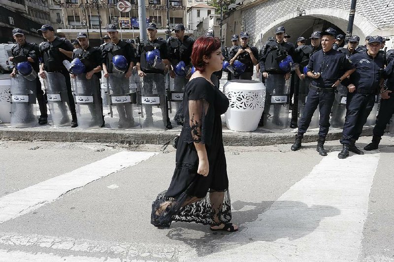 Algerian police officers line a street Friday in Algiers as pro-democracy protesters turned out in defiance of a crackdown on the demonstration. 