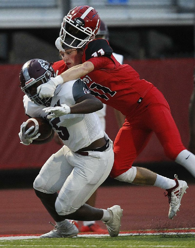 Cabot defensive back Kyle McIntire (right) loses his helmet as he hits Benton running back D’Anthony Harper during the first quarter Friday at Panther Stadium in Cabot. Cabot won 37-28. For more photos, go to arkansasonline.com/921benton/.