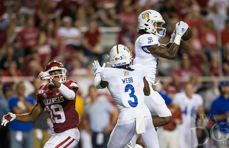 Bobby Brown II, San Jose State free safety, intercepts a pass intended for Tyson Morris (19), Arkansas wide receiver, in the second quarter Saturday, Sept. 21, 2019, at Reynolds Razorback Stadium in Fayetteville. 