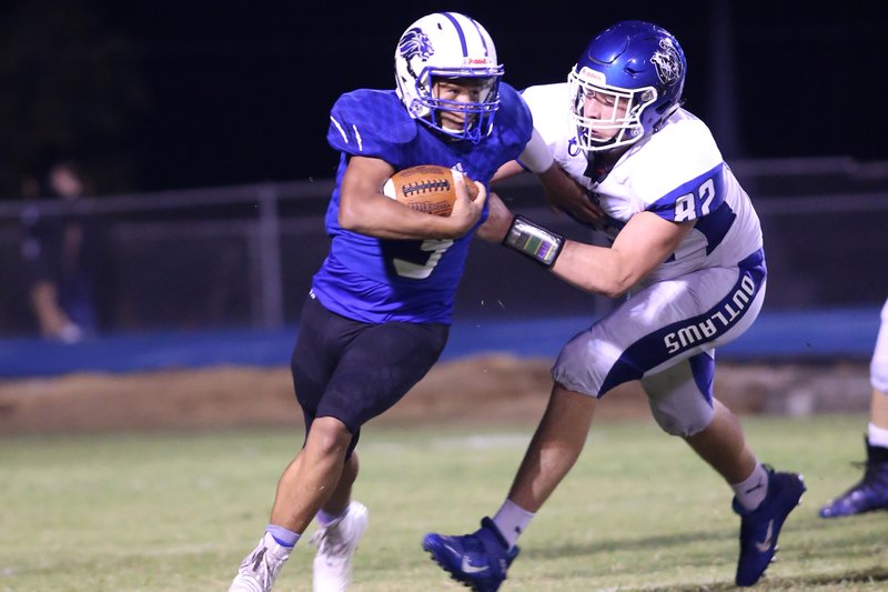 Jessieville sophomore Matthew Huff pushes past Dierks senior defensive end Bryce Fox in Friday's game at Don Phillips Field. The Lions cruised to a 41-13 victory over the Outlaws to enter the conference season with a 3-0 non-conference record. Photo by Corbet Deary for The Sentinel-Record