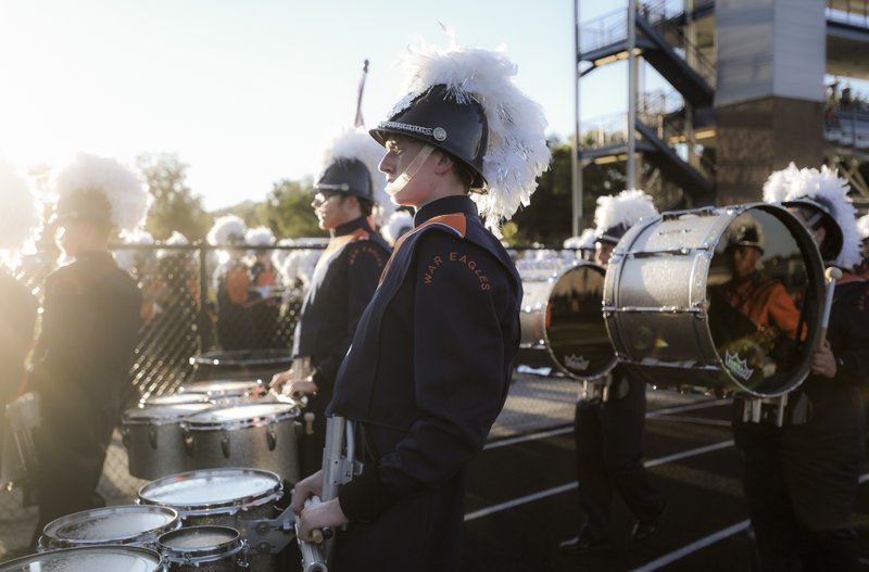 Rogers Heritage High School marching band members march during a football game, Friday, September 14, 2018 at Rogers Heritage High School in Rogers.