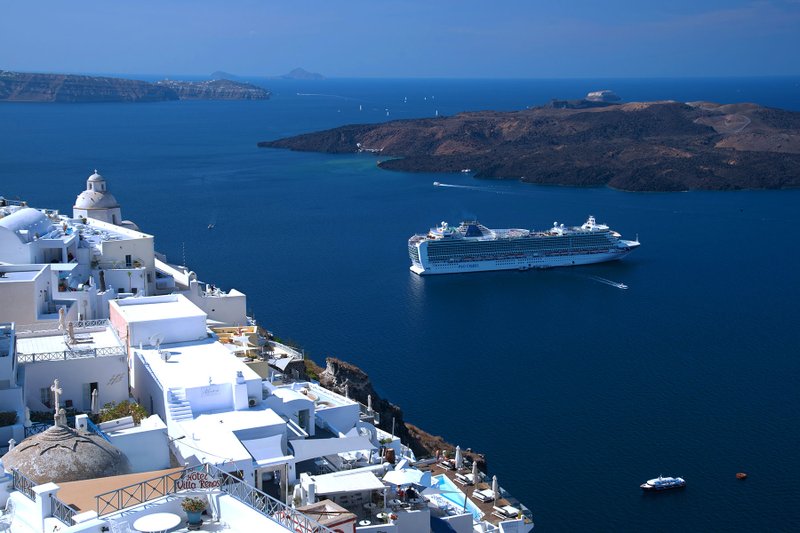 A cruise ship offers memorably fantastic views of the classic whitewashed villages of Santorini. (Photo by Cameron Hewitt via Rick Steves' Europe)