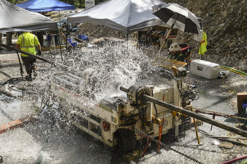 Groundwater sprays from the wellhead of the horizontal boring site at Blakely Mountain last week. Drillers have run into groundwater in the bedrock since setting up their rig last month. - Photo by Grace Brown of The Sentinel-Record