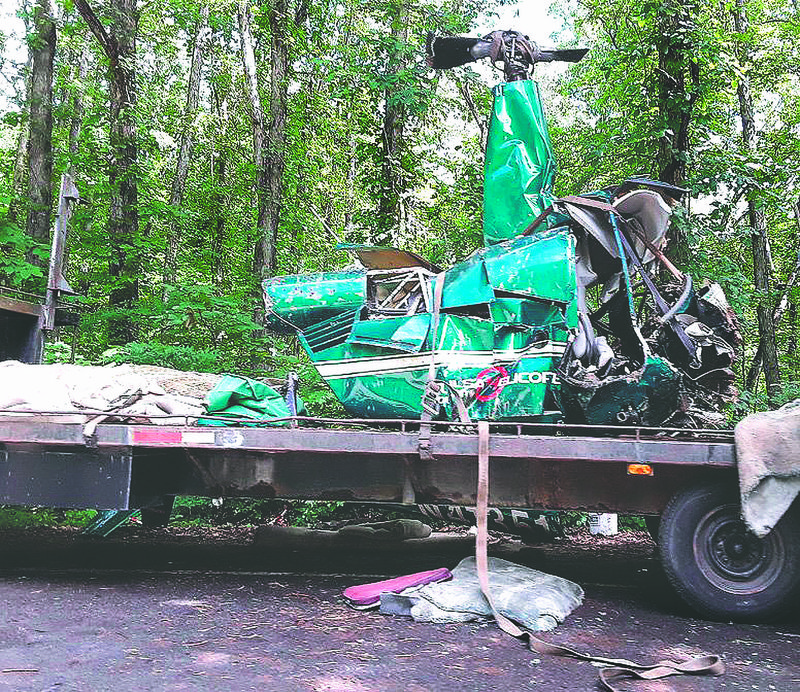 Courtesy Photo/ANASTASIA MARIE GRAHAM 
 A wrecked Tulsa County Helicopter sits June 6 on a flatbed trailer on Arkansas 23 in Franklin County. Three people were killed June 2 and one was injured in the helicopter crash near Mulberry Mountain north of Ozark, according to officials.