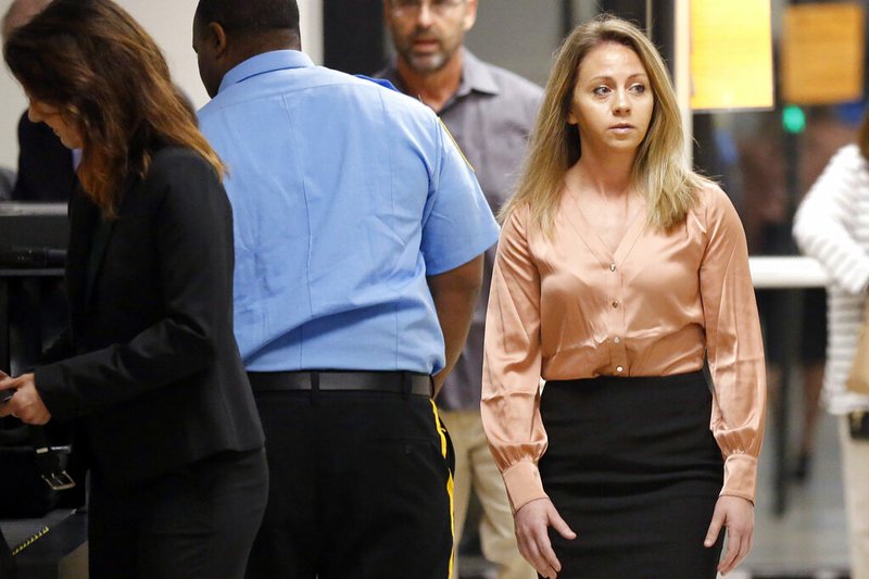 FILE - In this Sept. 13, 2019 file photo, fired Dallas police Officer Amber Guyger, right, arrives for jury selection in her murder trial at the Frank Crowley Courthouse in downtown Dallas. The murder trial for a Guyger who shot and killed Botham Jean, an unarmed black man in his Dallas apartment is set for opening arguments Monday Sept. 23, 2019. (Tom Fox/The Dallas Morning News via AP File)
