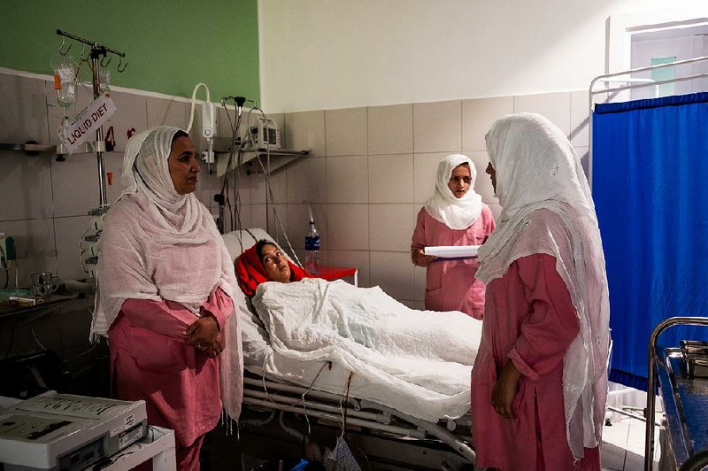 Maternity team leader Maria Salehi (left) and others tend to a patient at the Anabah center in July. “We’ve sort of become famous” among Afghan women, Salehi said. 