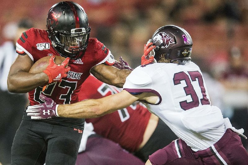 Arkansas State University running back Isaiah Azubuike tries to fend off Southern Illinois safety Mike Elbert on Sept. 21 at Centennial Bank Stadium in Jonesboro. See more photos at arkansasonline.com/922siuasufb/.