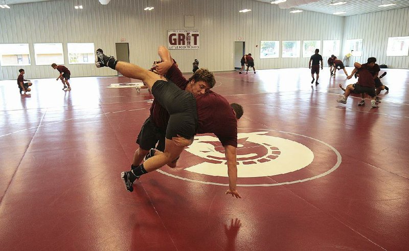 Members of the UALR wrestling team work out at the Greg Hatcher Wrestling Center in Little Rock for the first time Tuesday. The center will host its grand opening at 5:30 p.m. today. For more photos, go to arkansasonline.com/925wrestling.