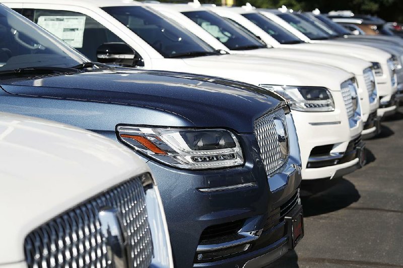 Lincoln Navigators are shown on a dealership lot in Englewood, Colo. Consumer spending, which accounts for about 70% of economic activity in the U.S., has shielded the economy from some of the effects of trade disputes. 