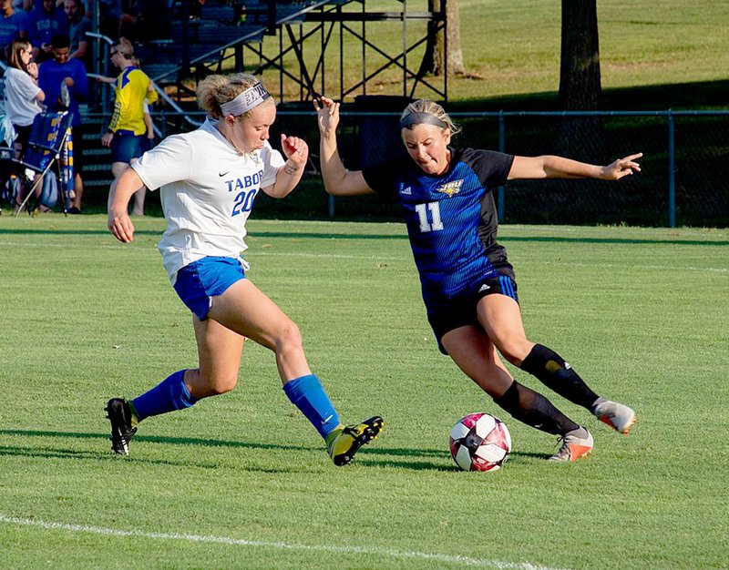 Photo courtesy of JBU Sports Information John Brown junior defender Anna Schuchardt goes one-on-one with Tabor's Natalie Ford during last Saturday's match at Alumni Field.