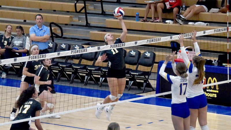 Photo courtesy of JBU Sports Information John Brown's Megan Beck goes up for a hit Saturday at Wayland Baptist in Plainview, Texas.