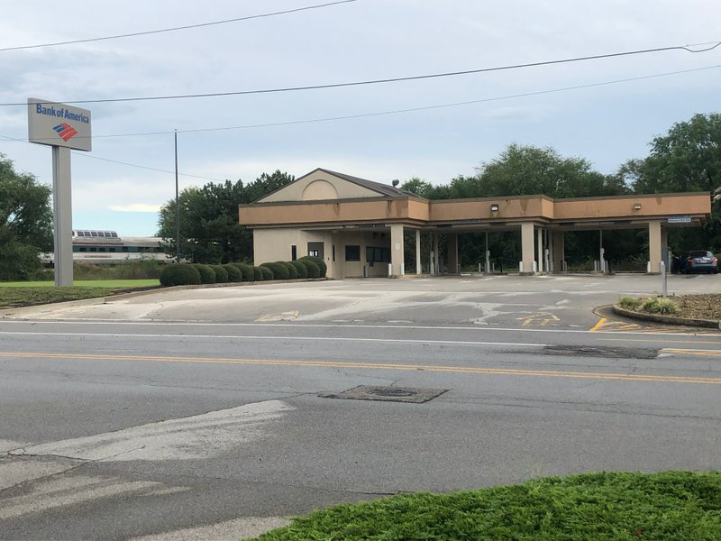NWA Democrat-Gazette/LAURINDA JOENKS Springdale's City Council accepted 2 acres in the downtown district from Bank of America. The city gained the complex which included the main bank building on West Emma Avenue and a drive-through on West Meadow Avenue.