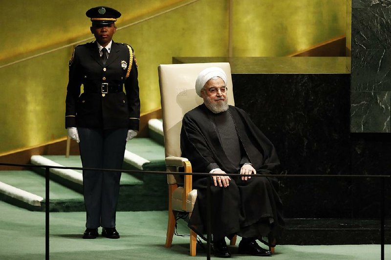 Iranian President Hassan Rouhani waits Wednesday to address the U.N. General Assembly. He labeled U.S. sanctions “international piracy” and warned that “a single blunder can fuel a big fire.” More photos are available at arkansasonline.com/926un/ 
