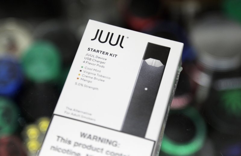 This Dec. 20, 2018, file photo shows a Juul electronic cigarette starter kit at a smoke shop in New York. Juul is the largest U.S. seller of electronic cigarettes, controlling about 70% of the market. 