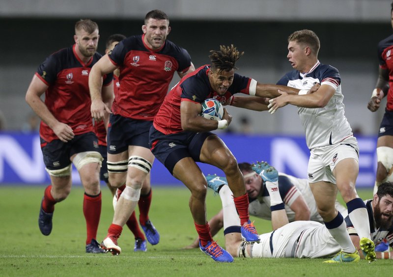 England's Anthony Watson is tackled by United States' Ruben de Haas, right, during Thursday's Rugby World Cup Pool C game at Kobe Misaki Stadium, between England and the United States in Kobe, Japan. Photo by Aaron Favila of The Associated Press