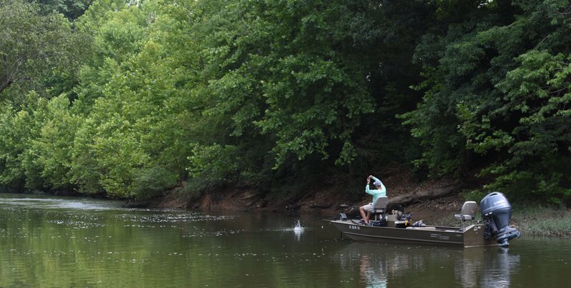 Mike Burnham of Benton is shown fishing on the Saline River near Benton.