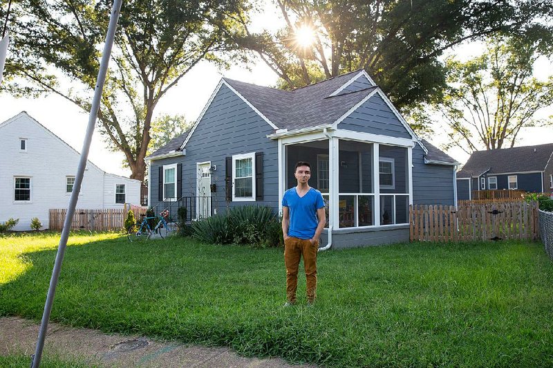 Jeisson Apolo Armas stands outside the house that he bought in 2018 through the Maggie Walker Community Land Trust in Chesterfield County, Virginia. 