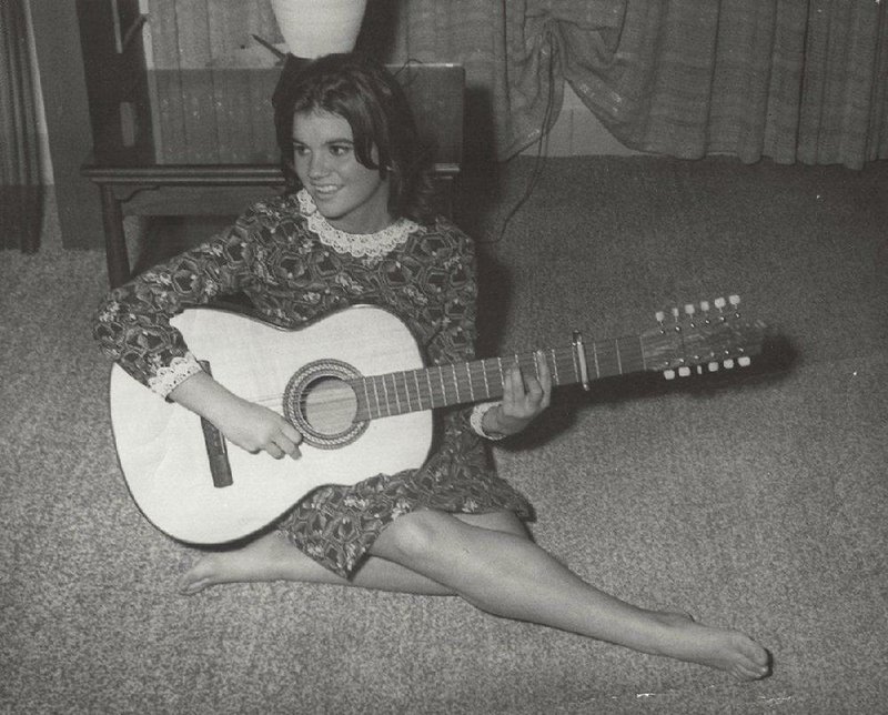 “Take this child, From Tucson, Arizona. Give her the wings to fly through harmony. And she won’t bother you no more”: A young Linda Rondstadt strums a 12-string guitar in her childhood home. 