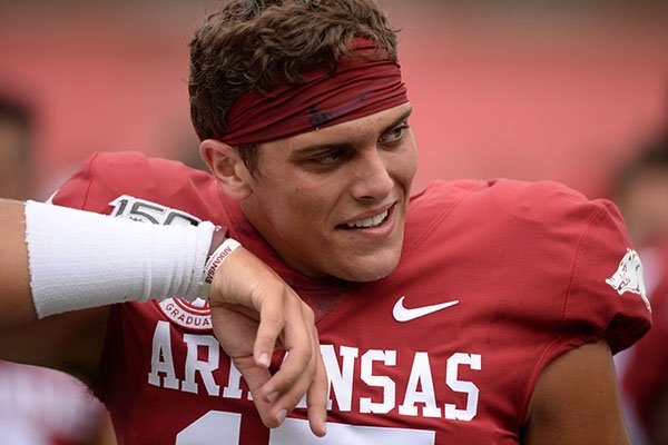 Arkansas quarterback Nick Starkel smiles Saturday, Aug. 24, 2019, after coming off the field following the first series during practice in Razorback Stadium in Fayetteville. 