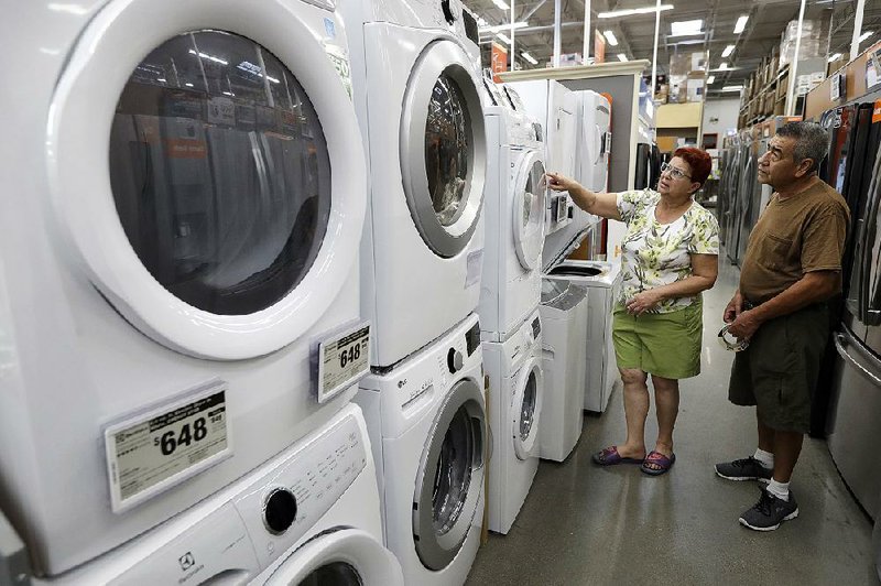 The Commerce Department says U.S. consumer spending rose 0.1% in August, the smallest gain in six months, while there was a 0.2% increase in orders for long-lasting manufactured goods, such as the clothes washers and dryers like these at a Home Depot store in Boston. 