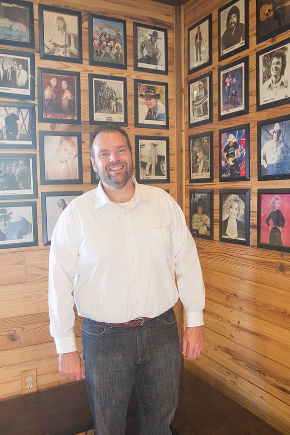 Clay Waliski of Carlisle, one of the owners of Nicks Bar-B-Q & Catfish, stands in front of the wall of fame inside the front doors of the restaurant that his grandparents started in 1972. The walls are adorned with photos of famous people who have eaten at the restaurant over the past 47 years. Waliski was recently named to the Arkansas State Board of Health by Gov. Asa Hutchinson.