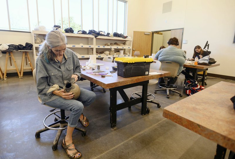 NWA Democrat-Gazette/SPENCER TIREY Rachel Ackerman, a student and English teacher at the Northwest Arkansas Community College, works on a ceramics project Friday in one of the art studios of the in the new Integrated Design Lab building. The college hosted a grand opening for its new building on its Bentonville campus. The building hosts courses in construction, fine arts, and computer-aided drafting.