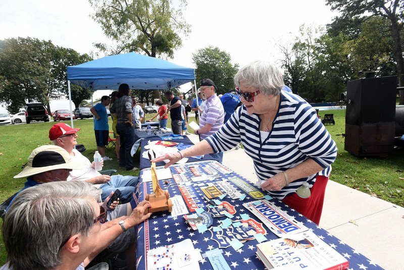 NWA Democrat-Gazette/FLIP PUTTHOFF Mary Ann Boyer decorates a table Saturday at the annual Little Flock Picnic hosted by the Democratic Party of Benton County.