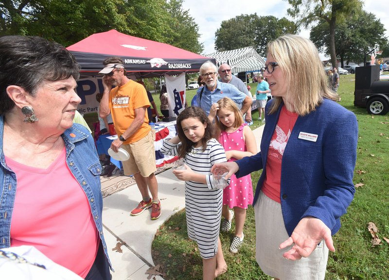 Celeste Williams (right), Democratic congressional candidate, talks Saturday with voters at the annual Little Flock Picnic.