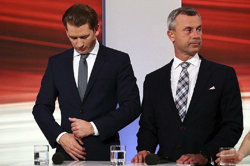 Norbert Hofer (right), leader of the right-wing Freedom Party, stands Sunday besides Austrian People’s Party candidate Sebastian Kurz before a TV interview in Vienna, Austria, after the closing of the polling stations for the Austrian national elections.