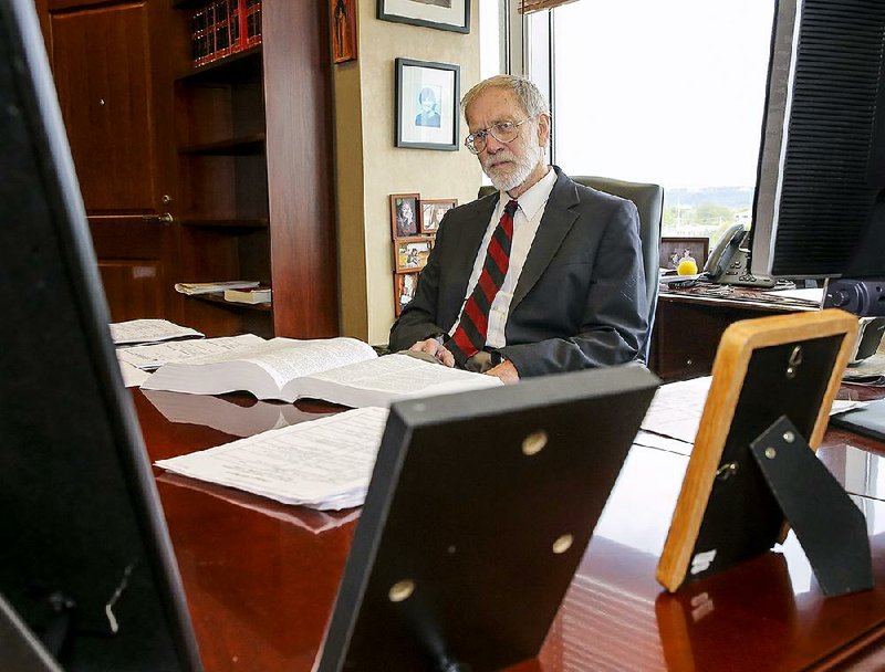 U.S. District Judge J. Leon Holmes, shown here in his office Thursday in Little Rock, will retire today after 15 years on the federal bench. 
